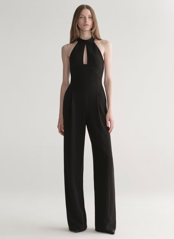 Black jumpsuit worn by a model on a white background