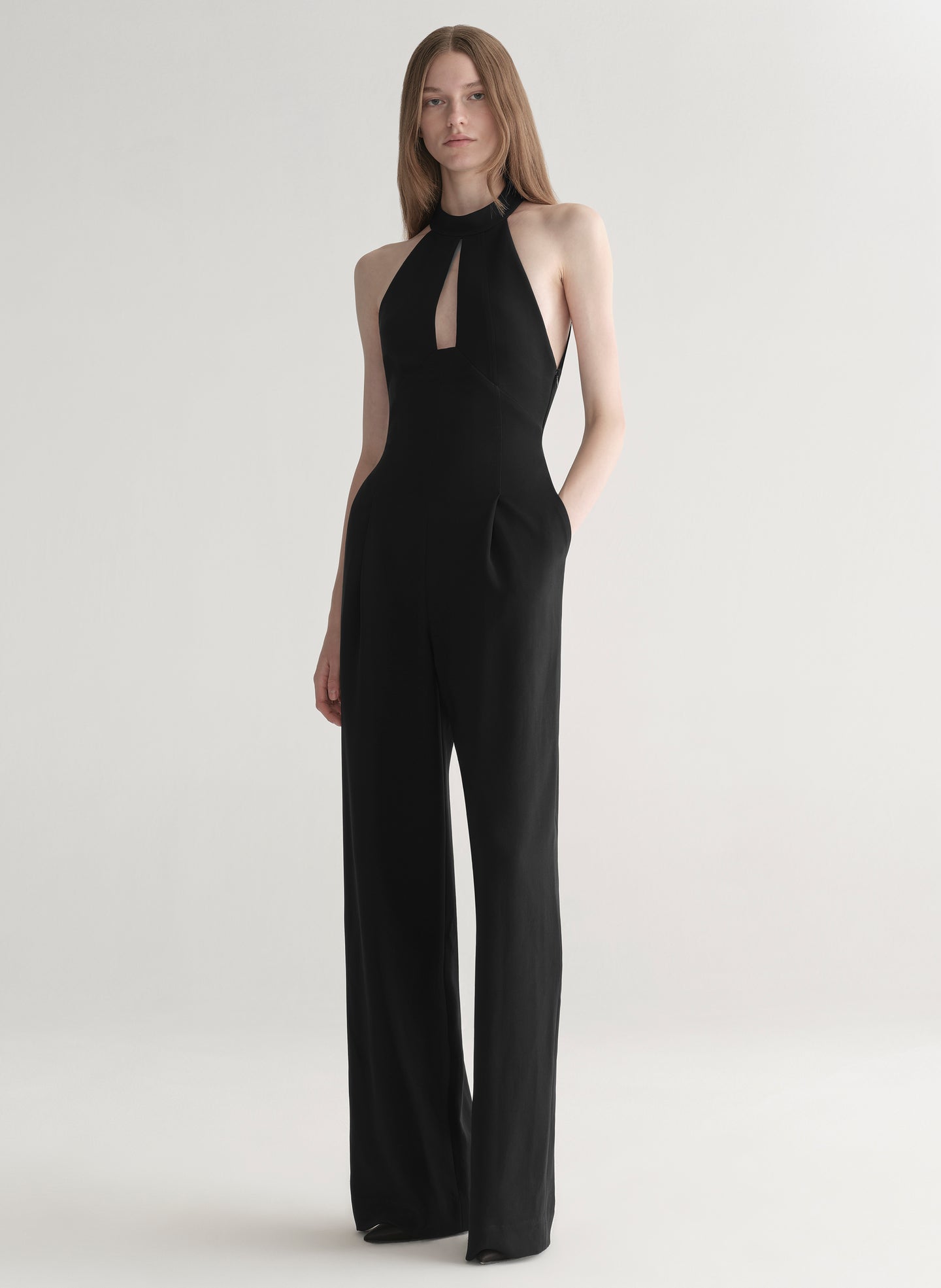 Black jumpsuit worn by a model on a white background