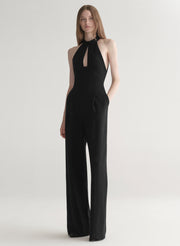 Black jumpsuit worn by a model on a white background