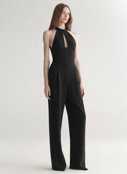 Black jumpsuit worn by a model on a white background
