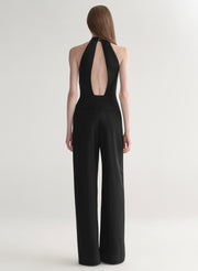 Black jumpsuit with open back on a white background