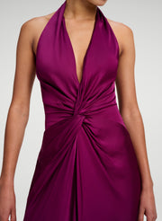 woman in a jewel colored gown with twist detail at front 