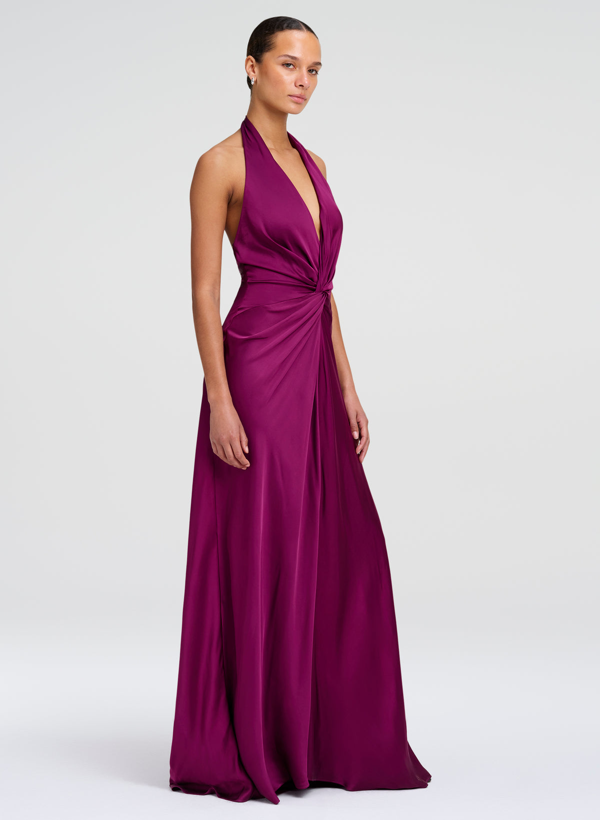 woman wearing a jewel tone floor length gown