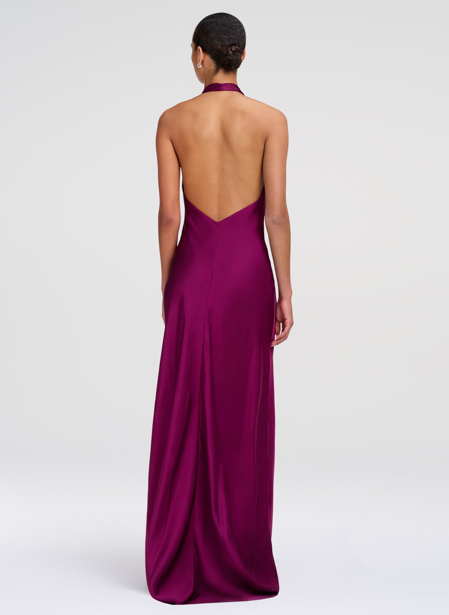 woman wearing jewel gown with open back