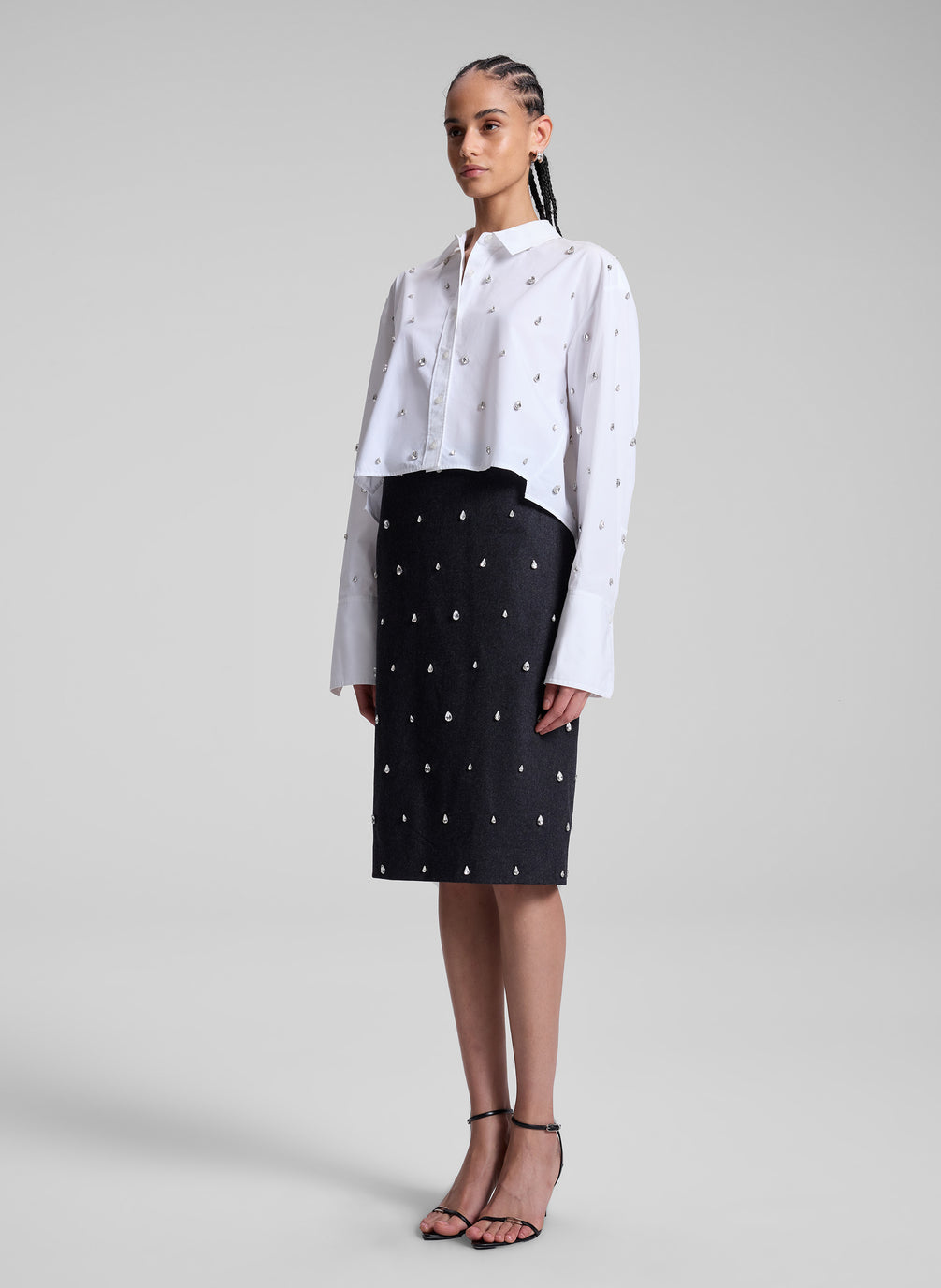 woman wearing white embellished shirt and black embellished skirt