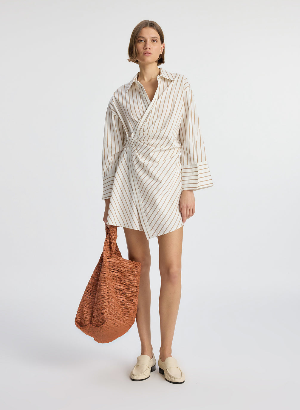 front view of woman wearing cream and brown striped wrapped shirtdress