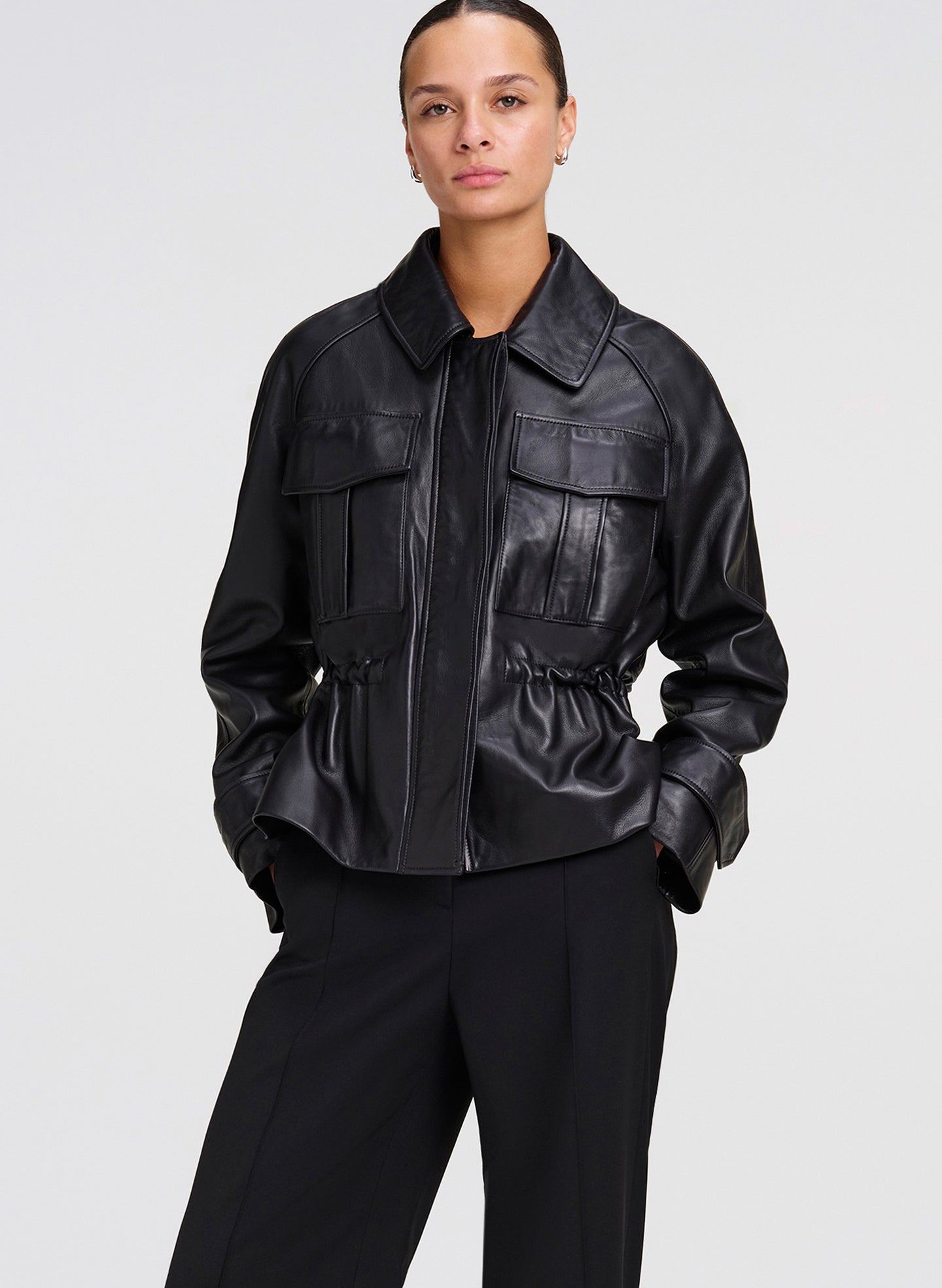 woman wearing black leather jacket with black pants