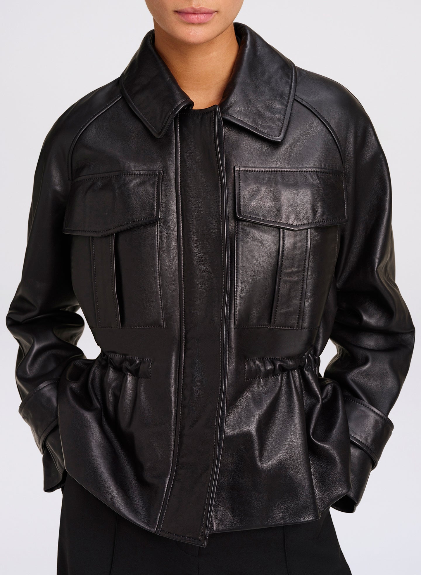 woman wearing black leather jacket with pockets - close up