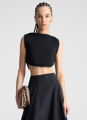 woman wearing black cropped tank and black midi skirt