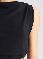 woman wearing black cropped tank and black midi skirt