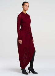 woman wearing red draped jersey dress