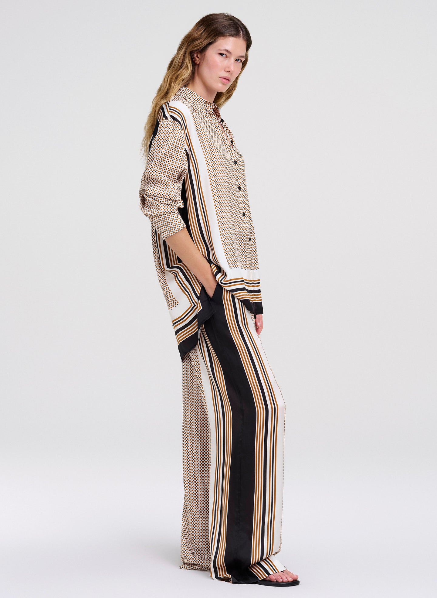Woman wearing a patterned outfit on a white background