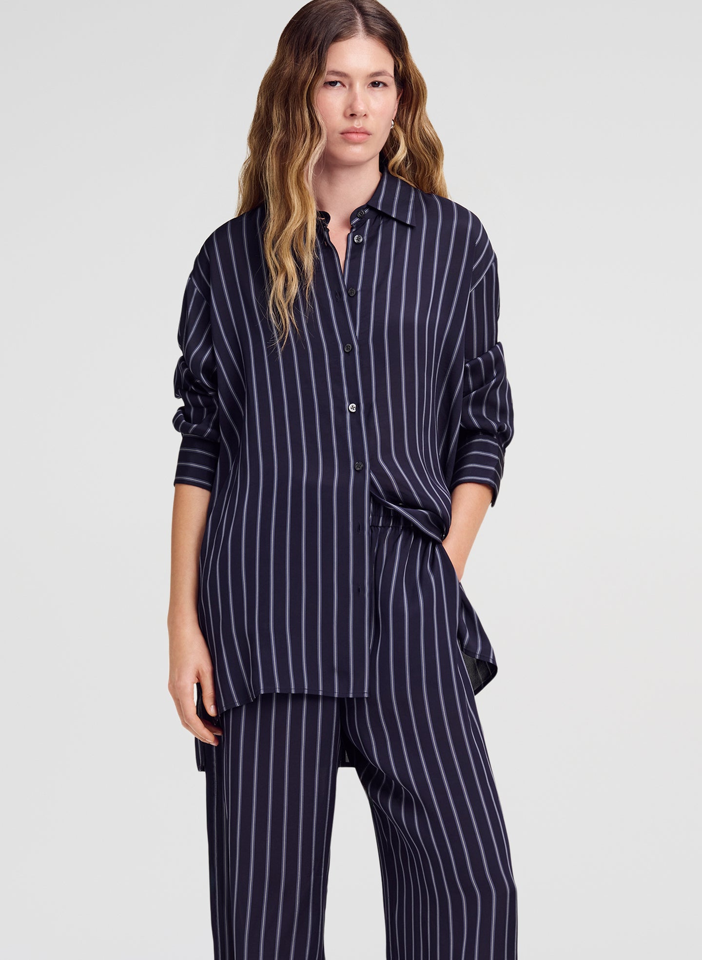 woman wearing striped top and matching pant