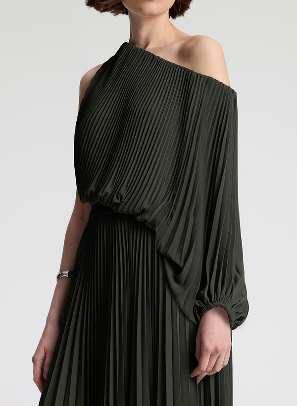 Woman wearing a dark green off-shoulder dress on a white background