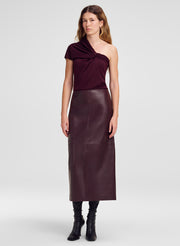 woman win one shoulder knit top and burgundy leather midi skirt