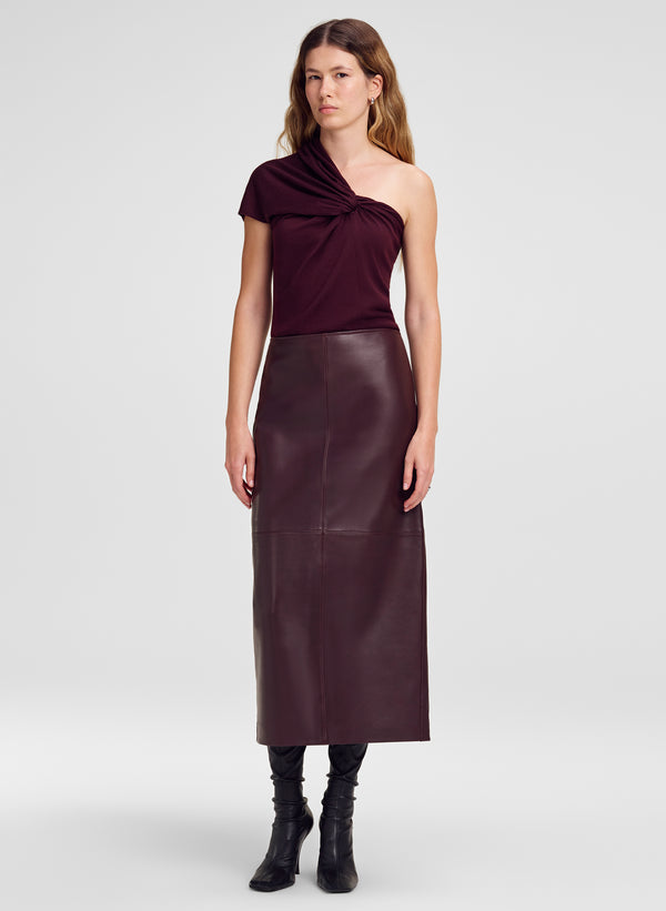 woman win one shoulder knit top and burgundy leather midi skirt