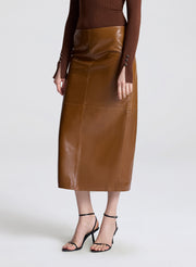 Brown leather skirt worn by a person on a white background