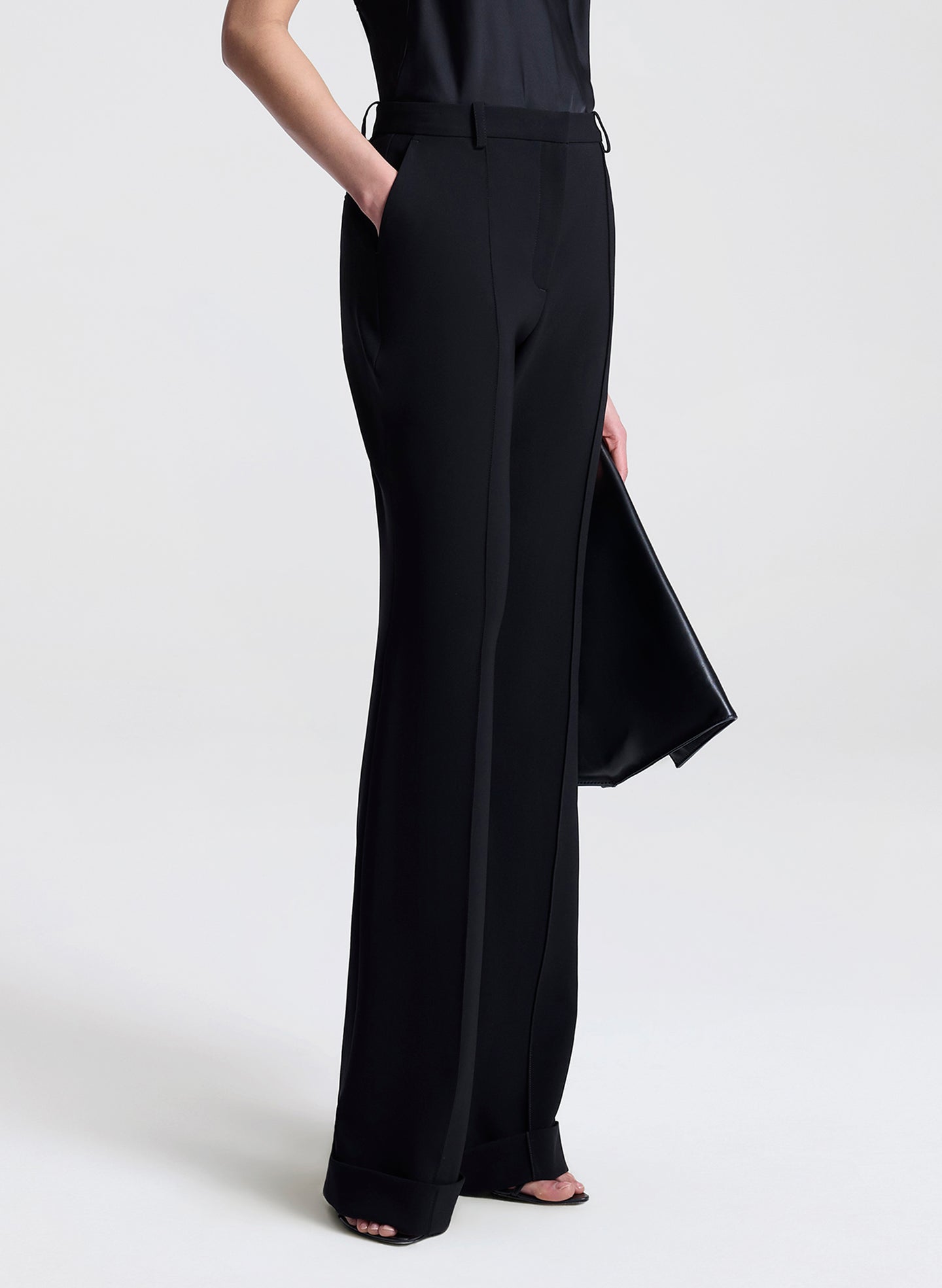 Black wide-leg pants worn by a person on a white background