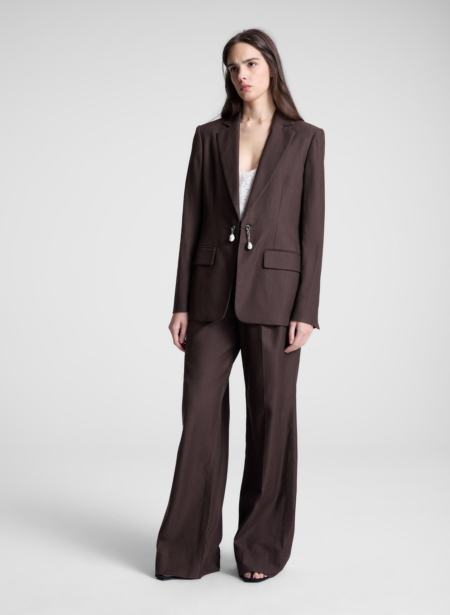woman wearing dark brown embellished blazer and matching pant