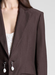 woman wearing dark brown embellished blazer and matching pant