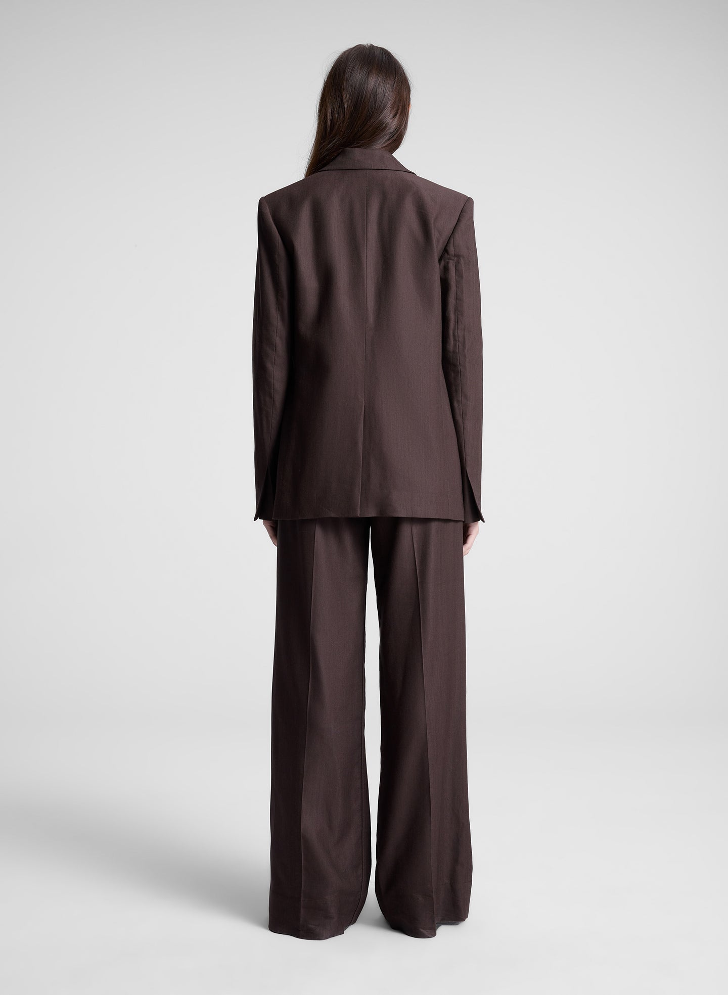 woman wearing dark brown embellished blazer and matching pant