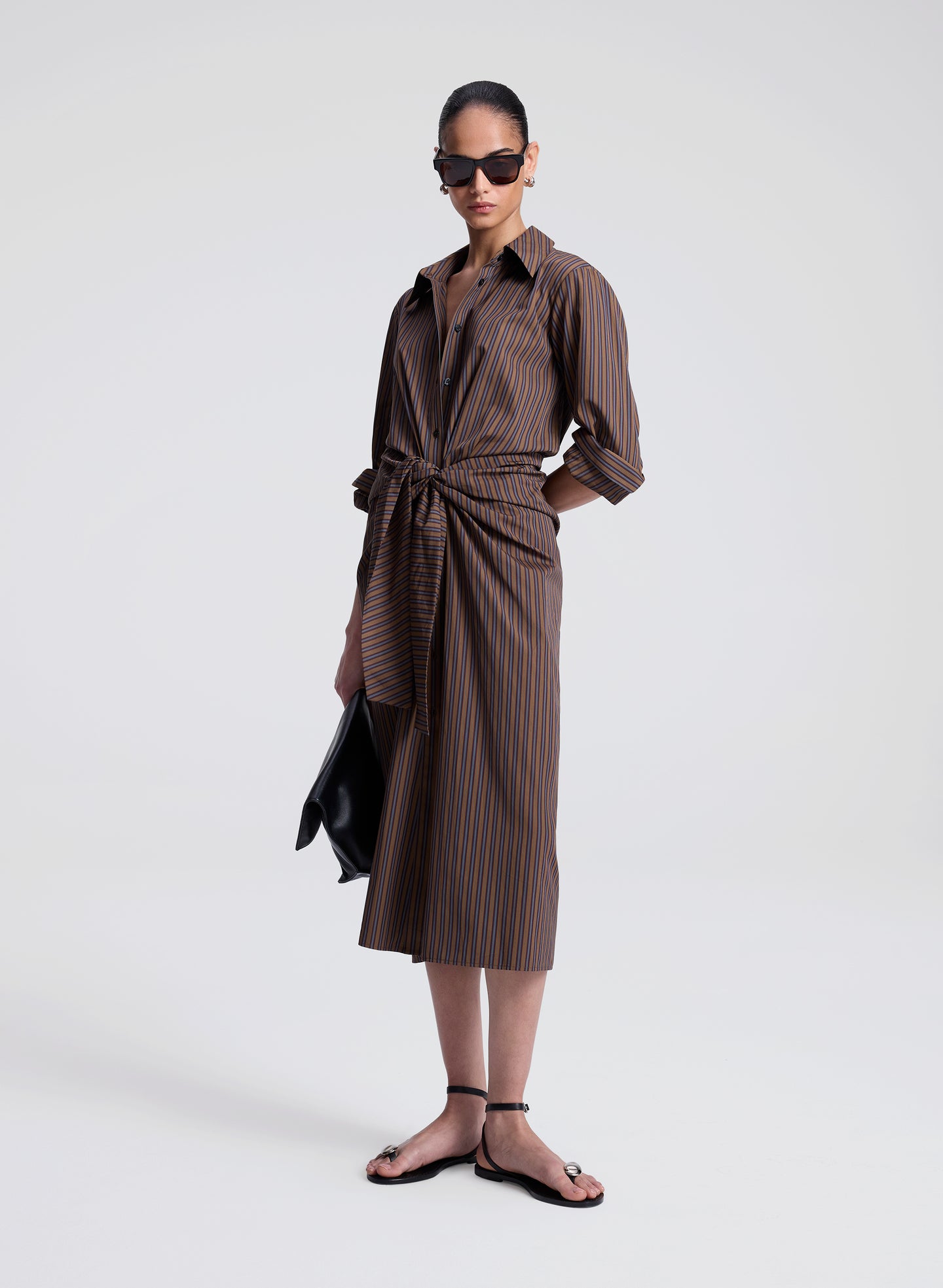 woman wearing brown striped midi shirtdress