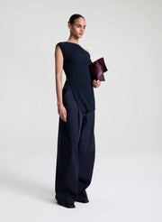 woman wearing navy blue off shoulder knit top with navy blue pants