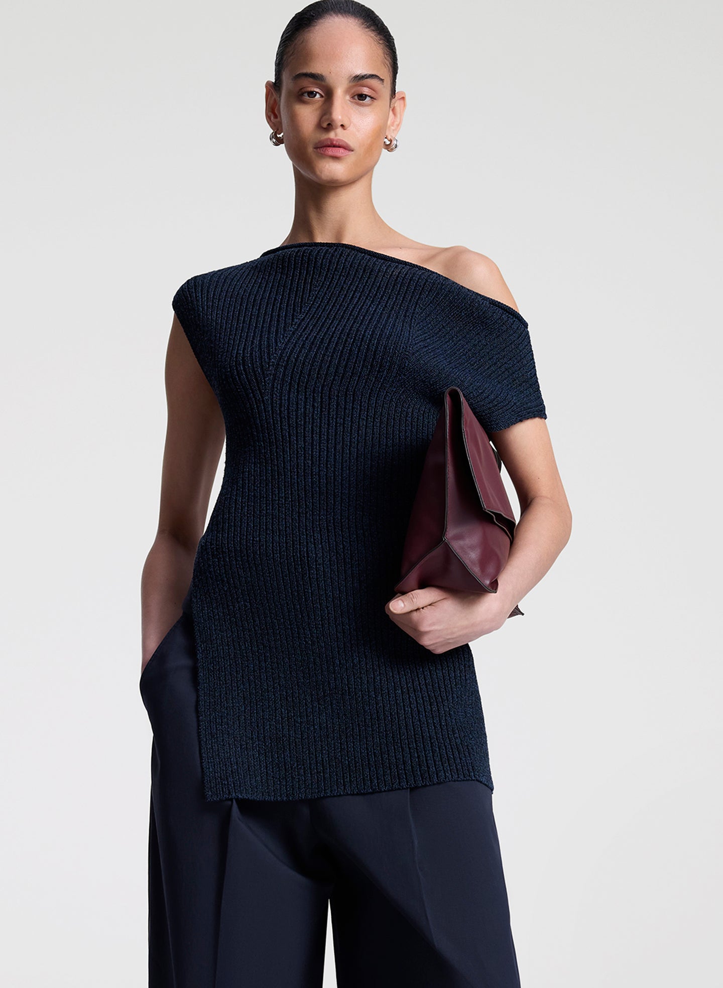 woman wearing navy blue off shoulder knit top with navy blue pants