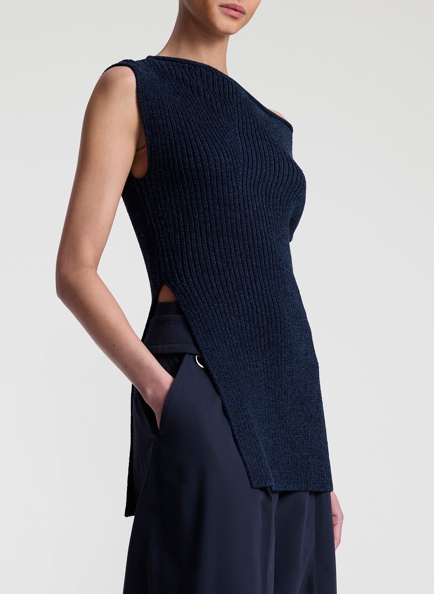 woman wearing navy blue off shoulder knit top with navy blue pants