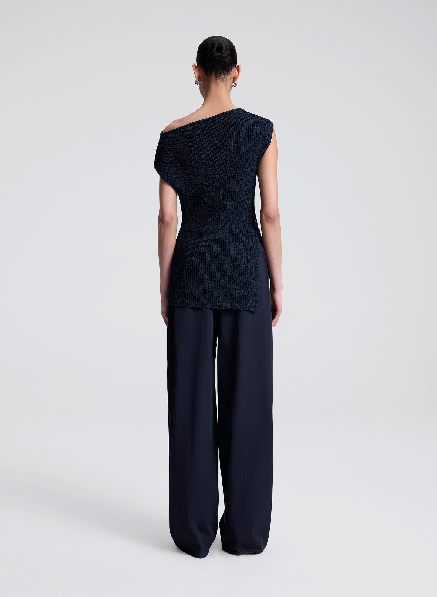 woman wearing navy blue off shoulder knit top with navy blue pants