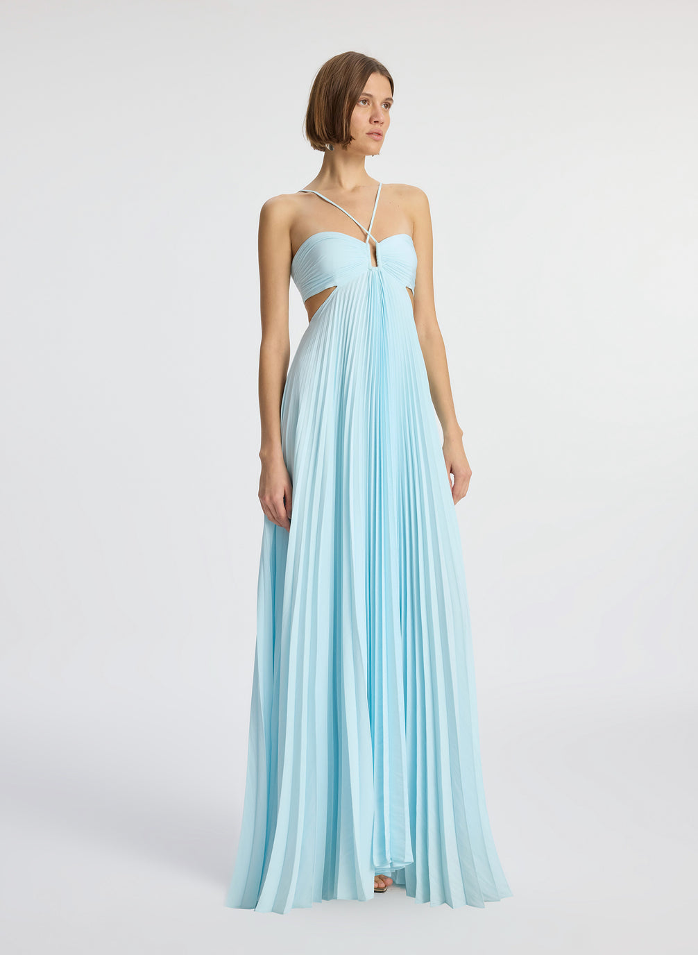 side view of woman wearing aqua satin pleated gown