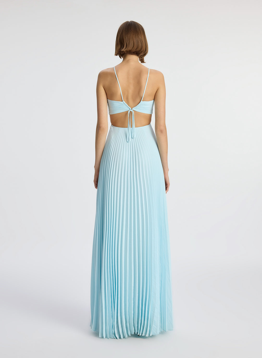 back  view of woman wearing aqua satin pleated gown