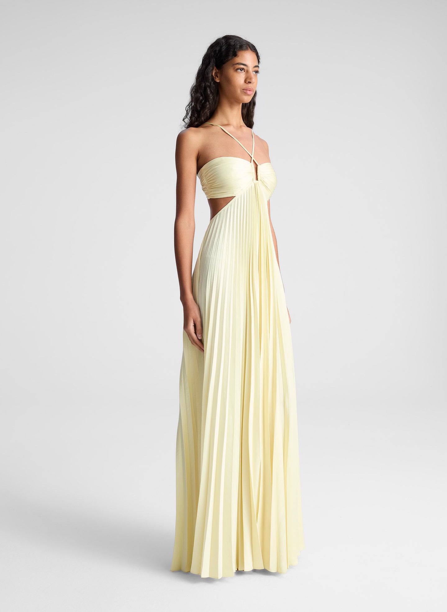 woman wearing light yellow maxi dress