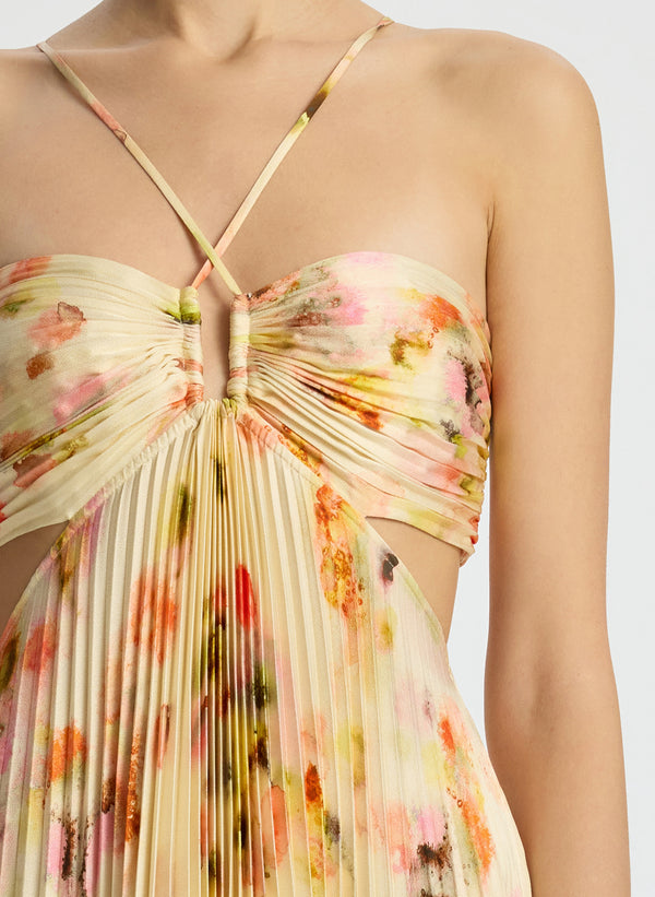 detail view of woman wearing yellow pleated maxi dress