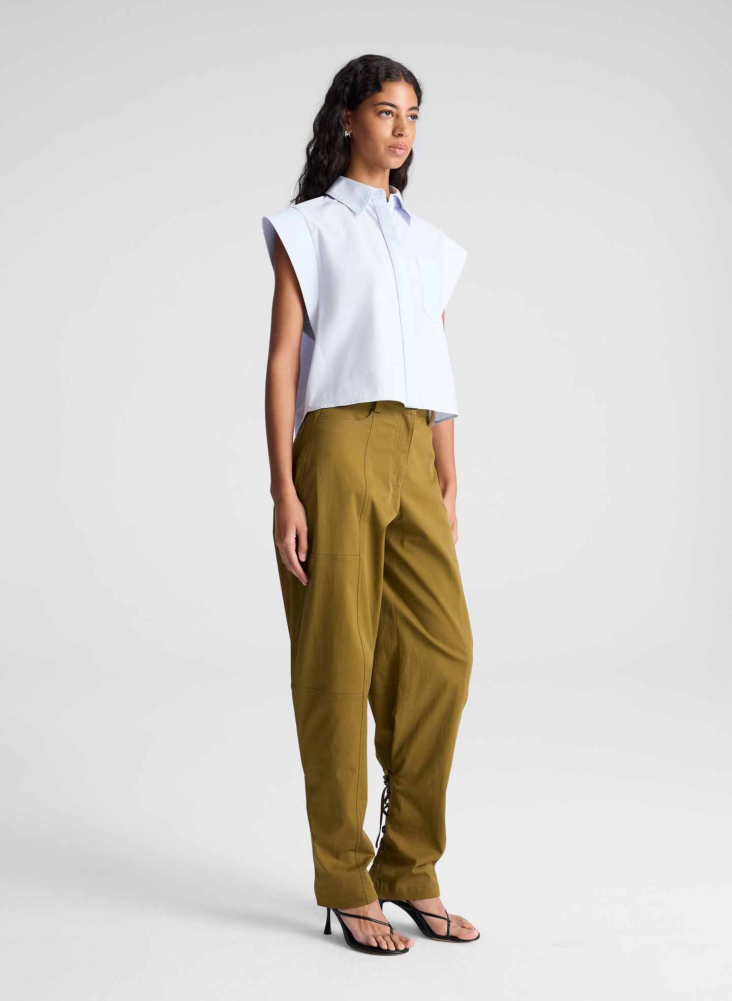 woman wearing light blue top and green pants