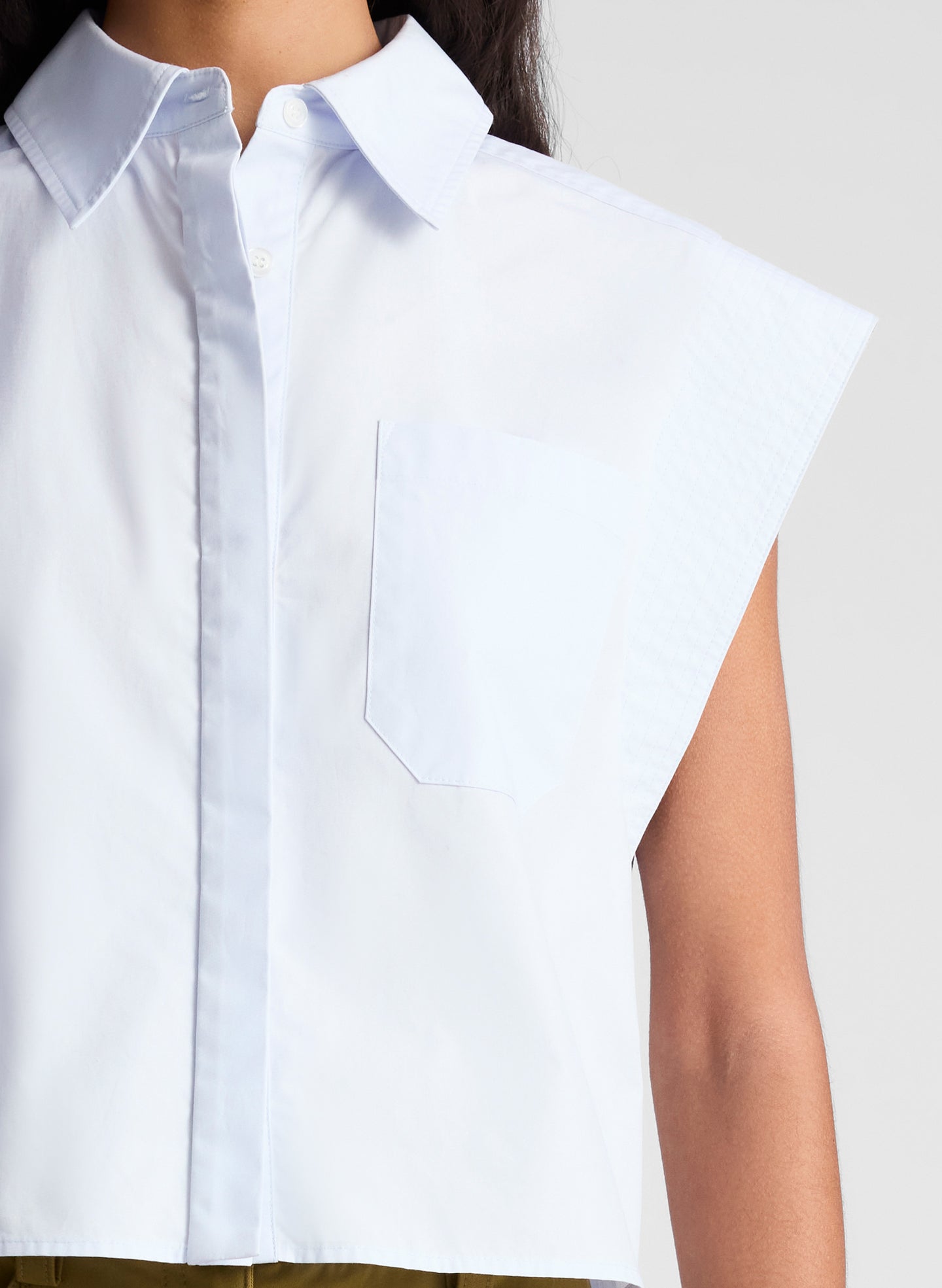 woman wearing light blue top and green pants