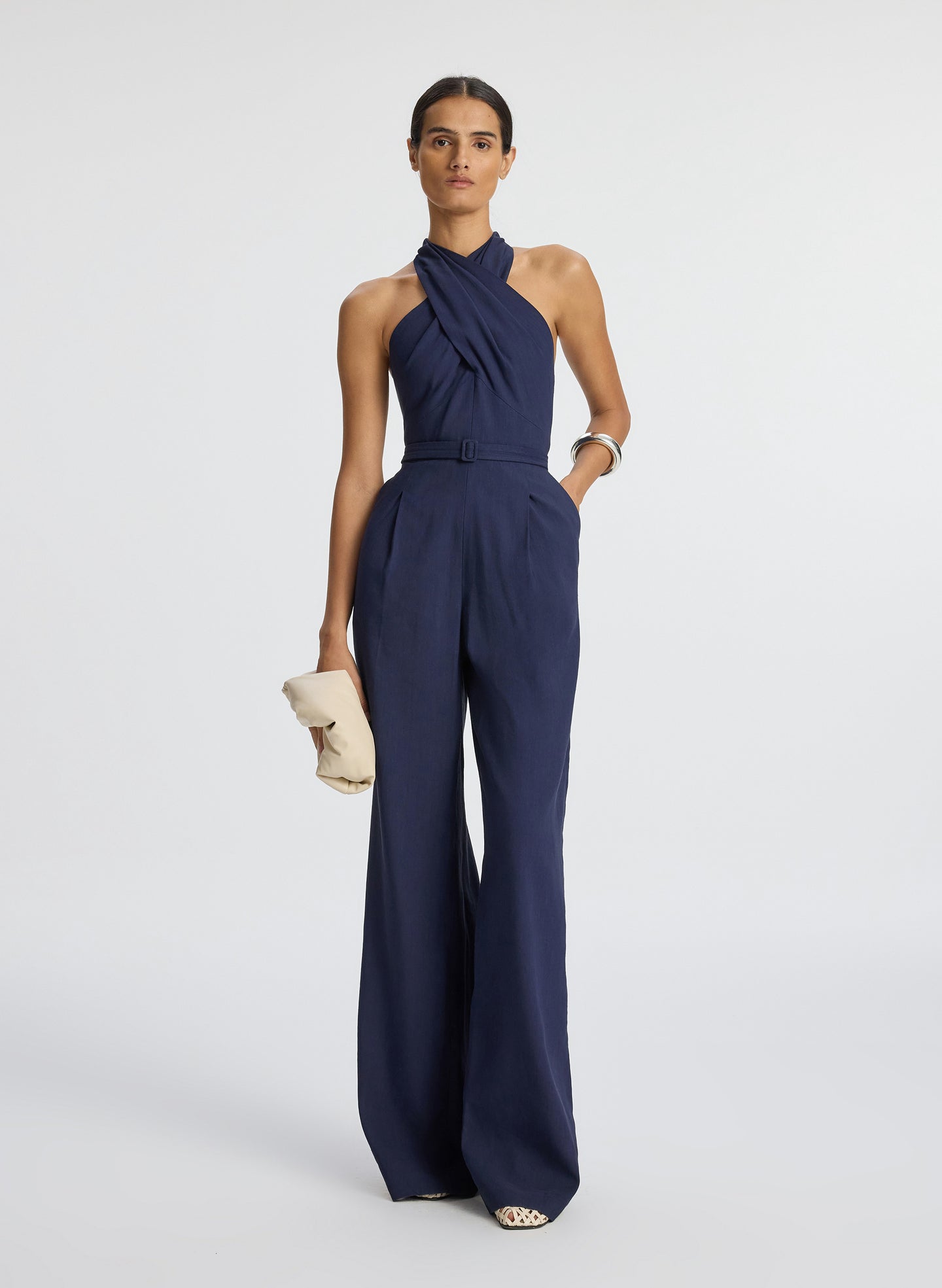 Front view of woman wearing navy blue sleeveless jumpsuit