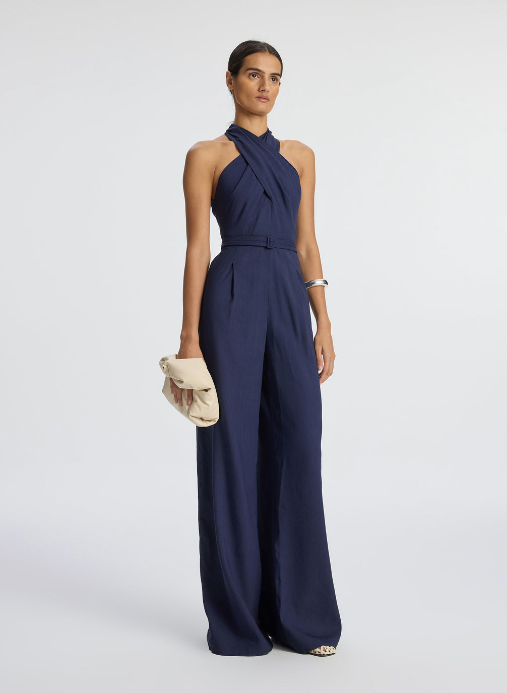 side view of woman wearing navy blue sleeveless jumpsuit