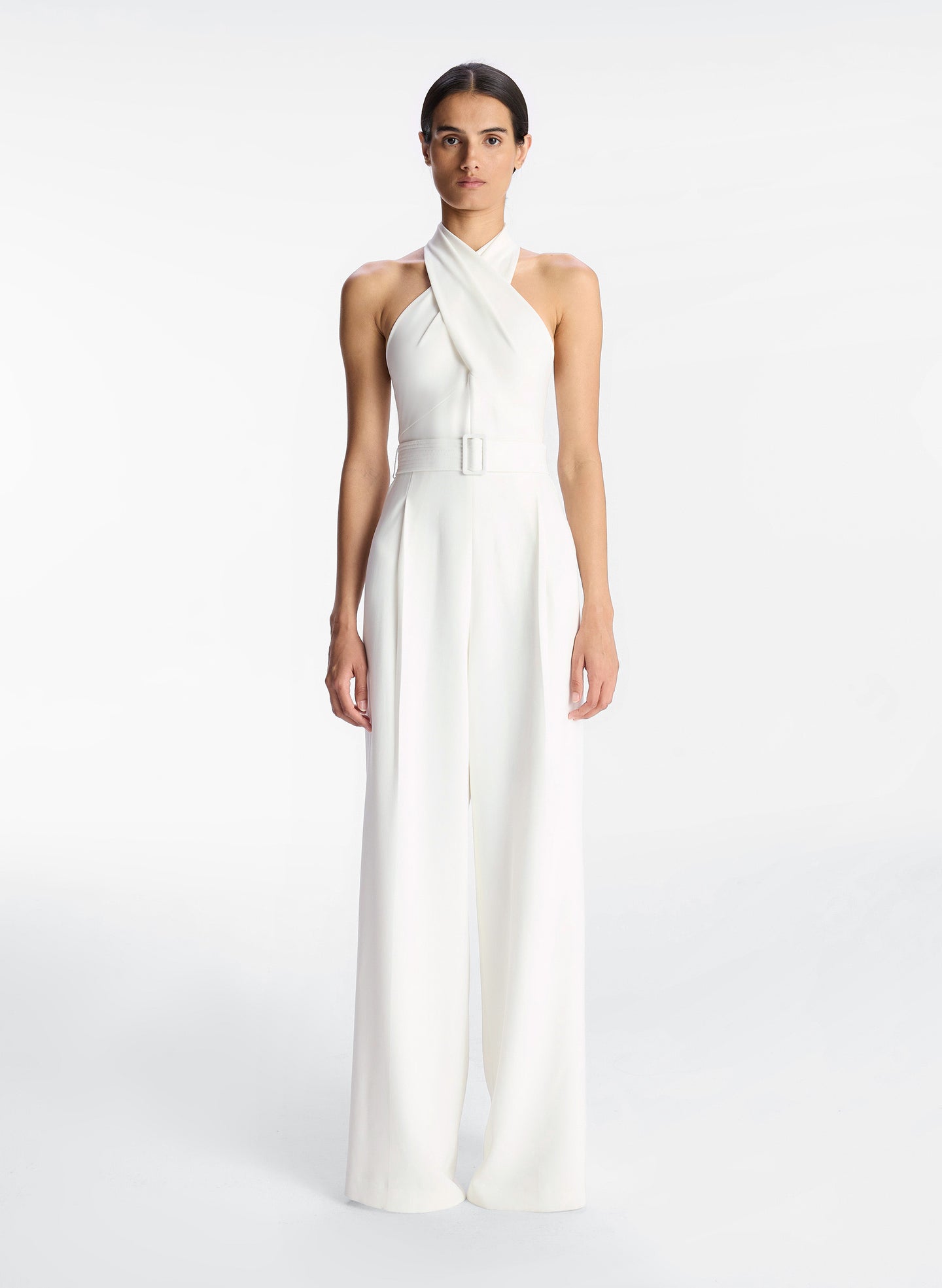 front view of woman in white sleeveless wide leg jumpsuit