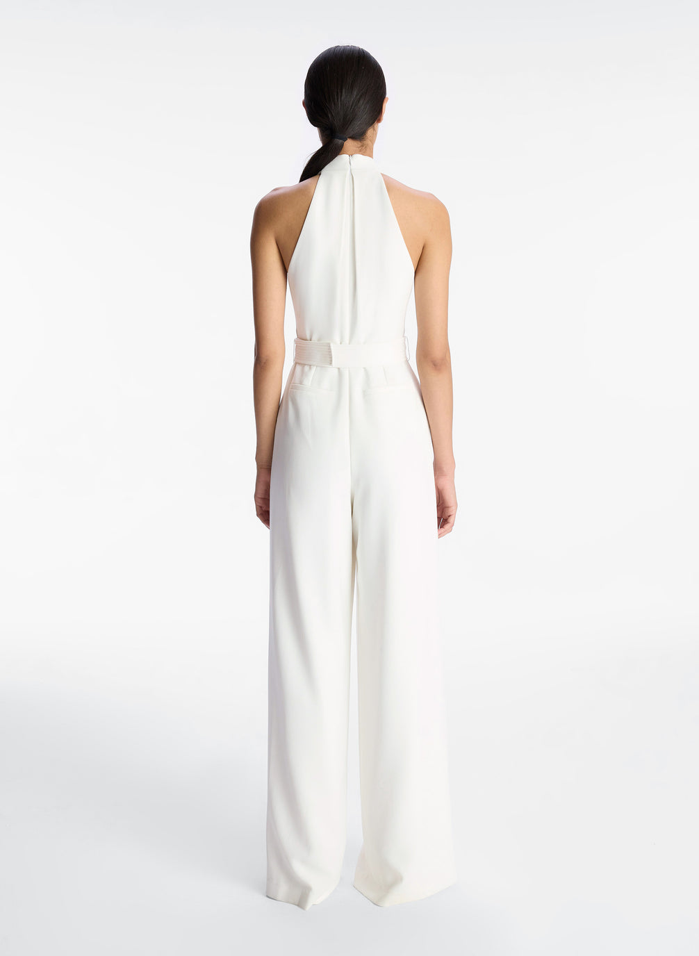 back view of woman in white sleeveless wide leg jumpsuit