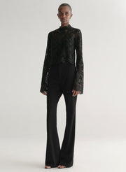 woman wearing black lace top with black pants