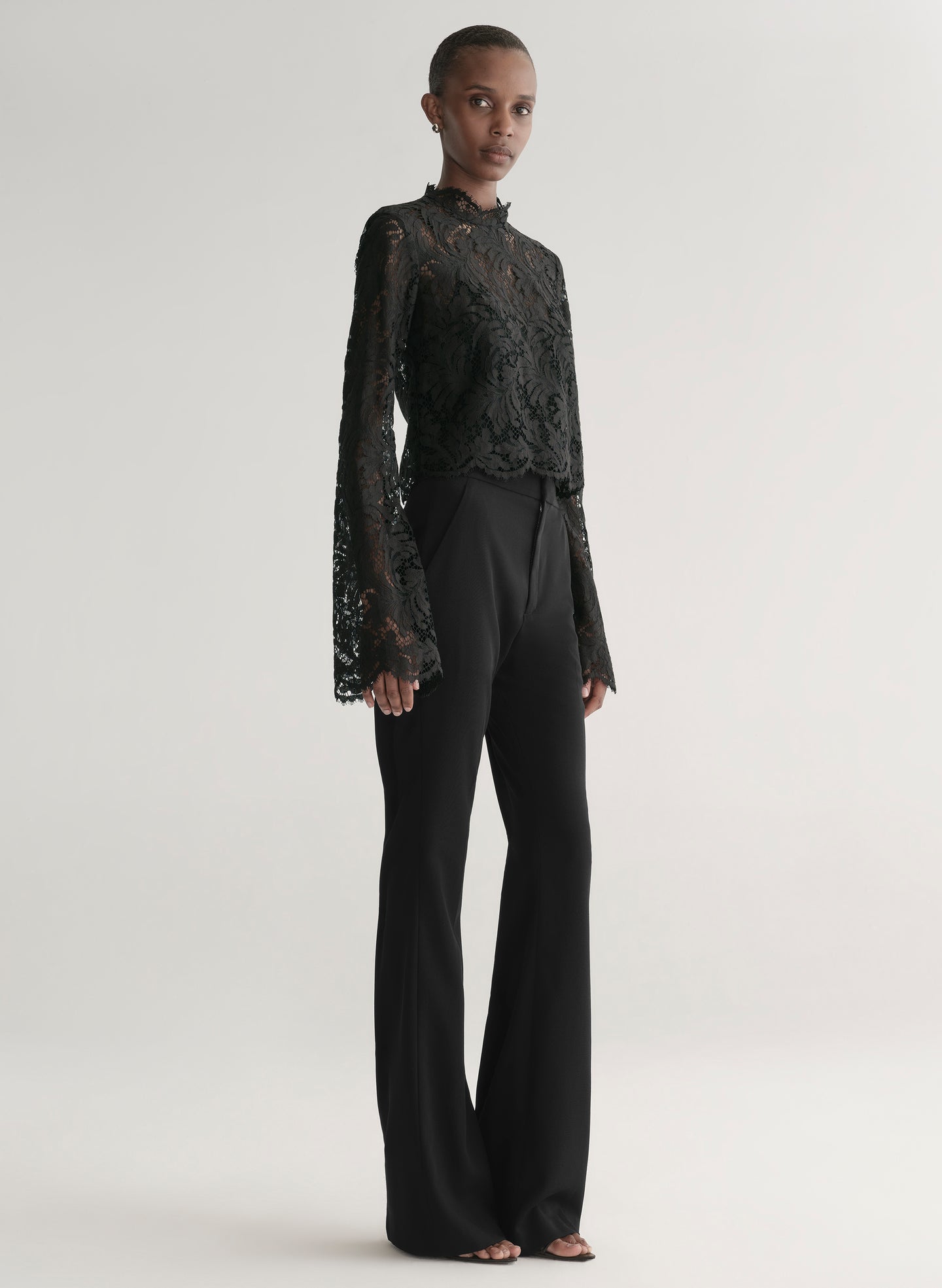 woman wearing black lace top with black pants
