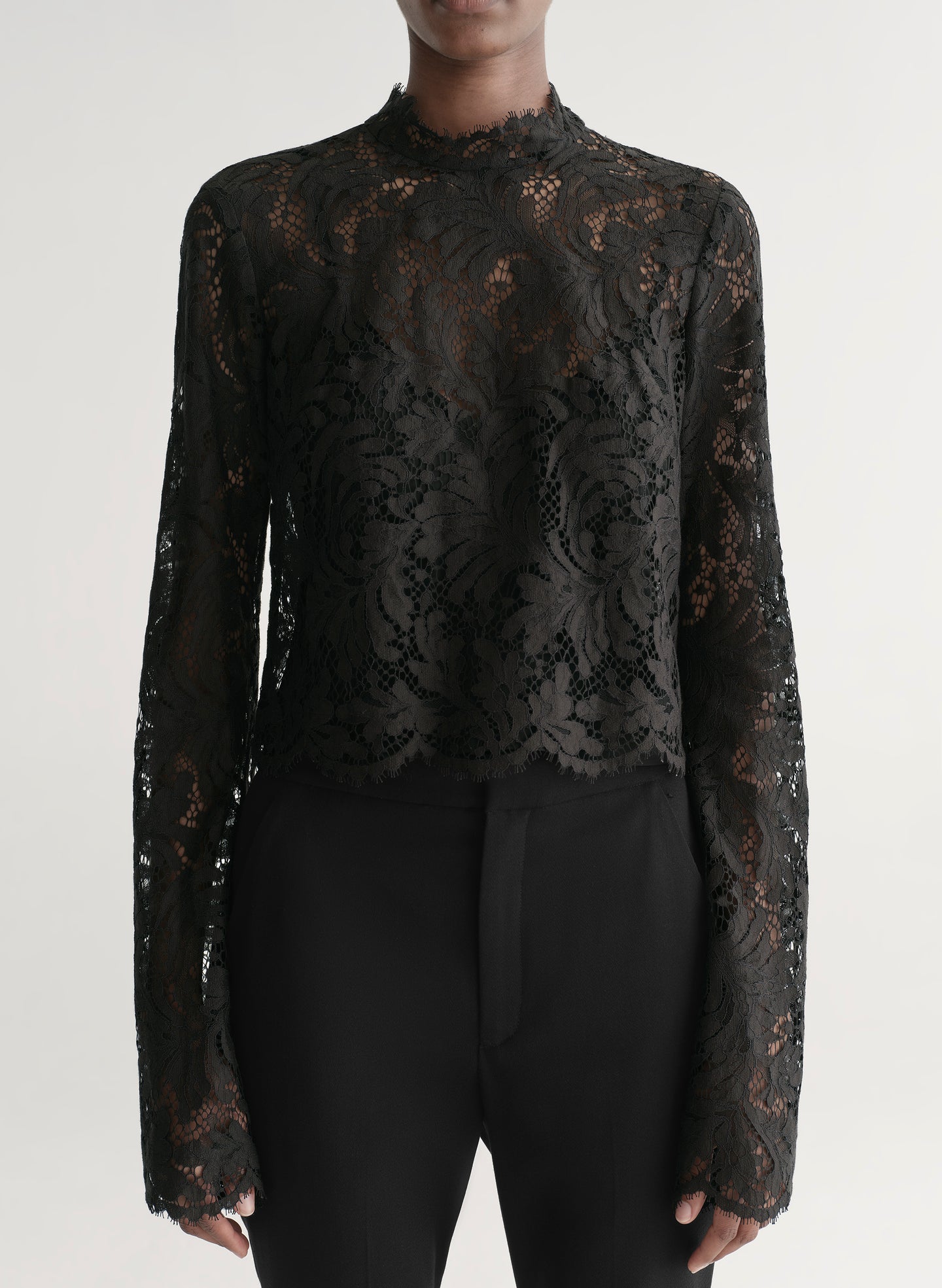 woman wearing black lace top with black pants