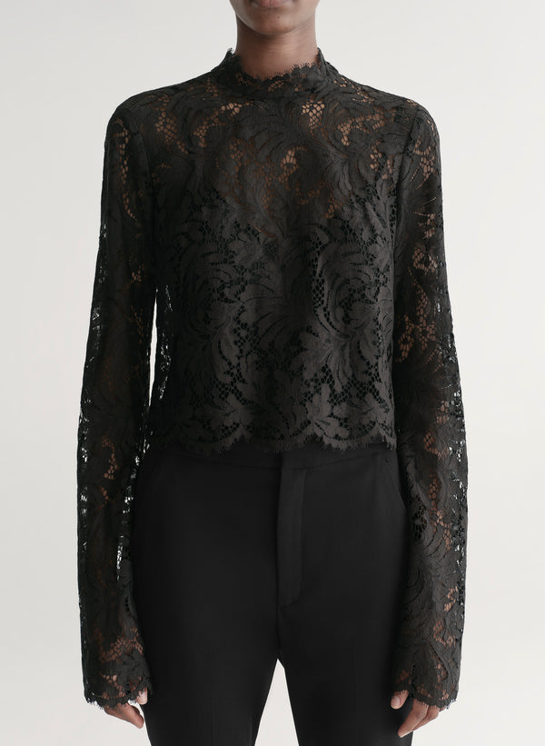 woman wearing black lace top with black pants