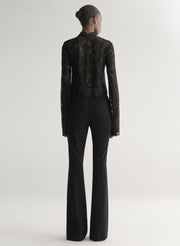 woman wearing black lace top with black pants