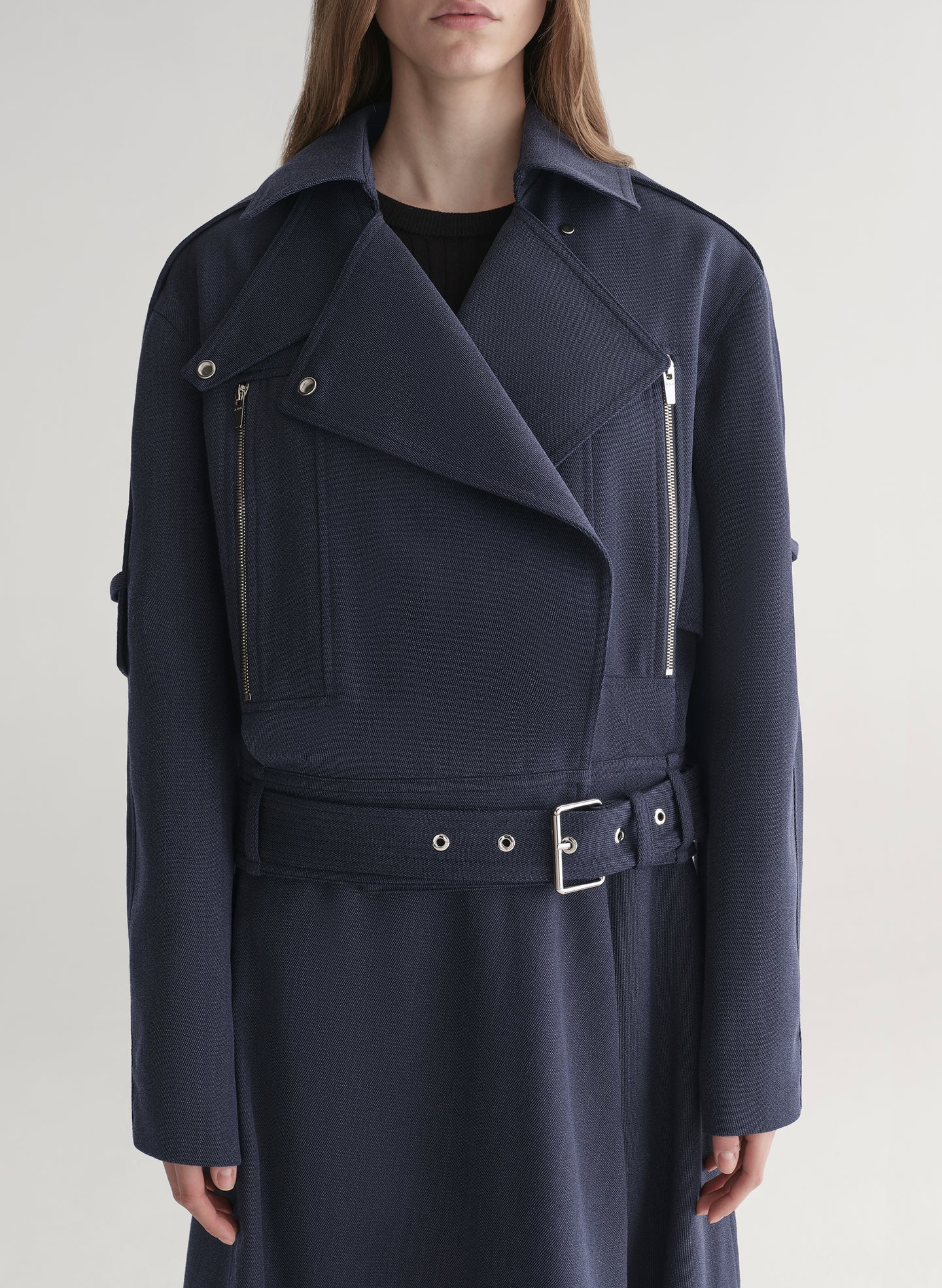 woman wearing navy blue jacket and matching skirt