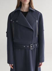 woman wearing navy blue jacket and matching skirt