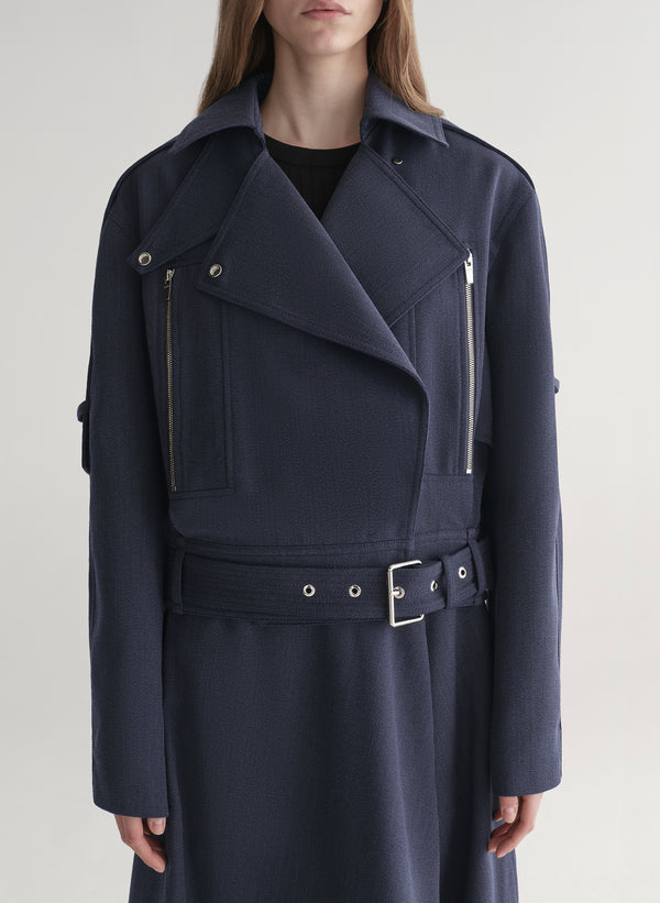 woman wearing navy blue jacket and matching skirt