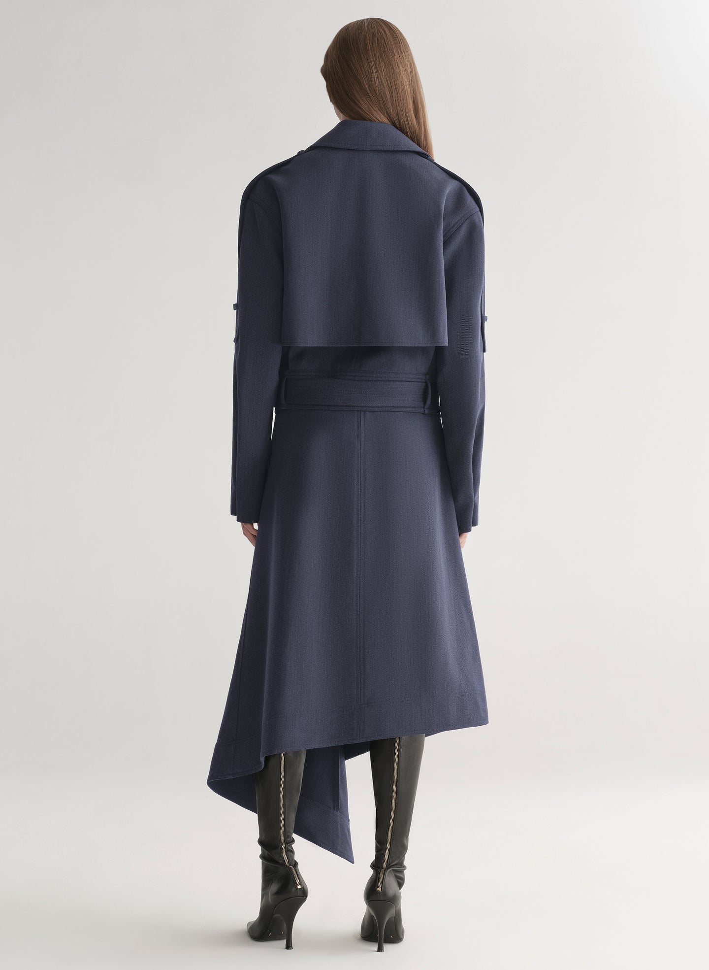 woman wearing navy blue jacket and matching skirt