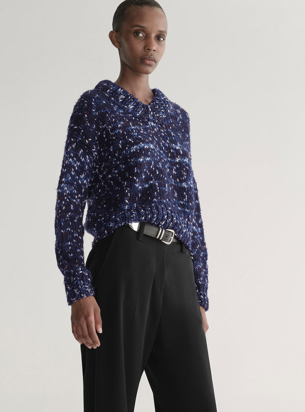 woman wearing blue sweater and black pants